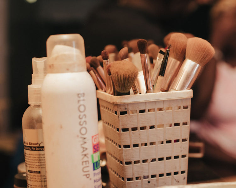 A collection of makeup brushes and beauty products neatly organized in a holder.